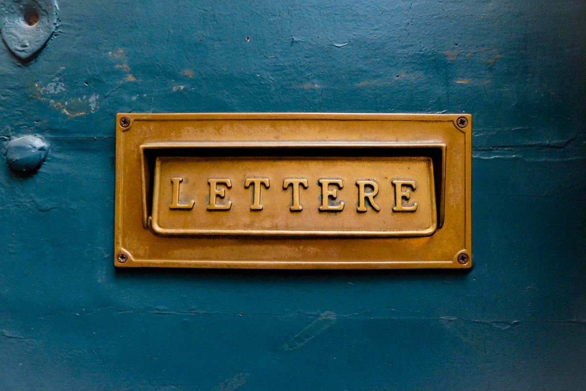 Golden letterbox slot in blue door