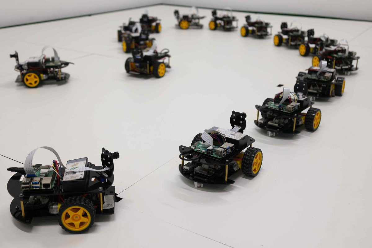 [Translate to Englisch:] Mehrere kleine Roboter fahren in Reihe hintereinander