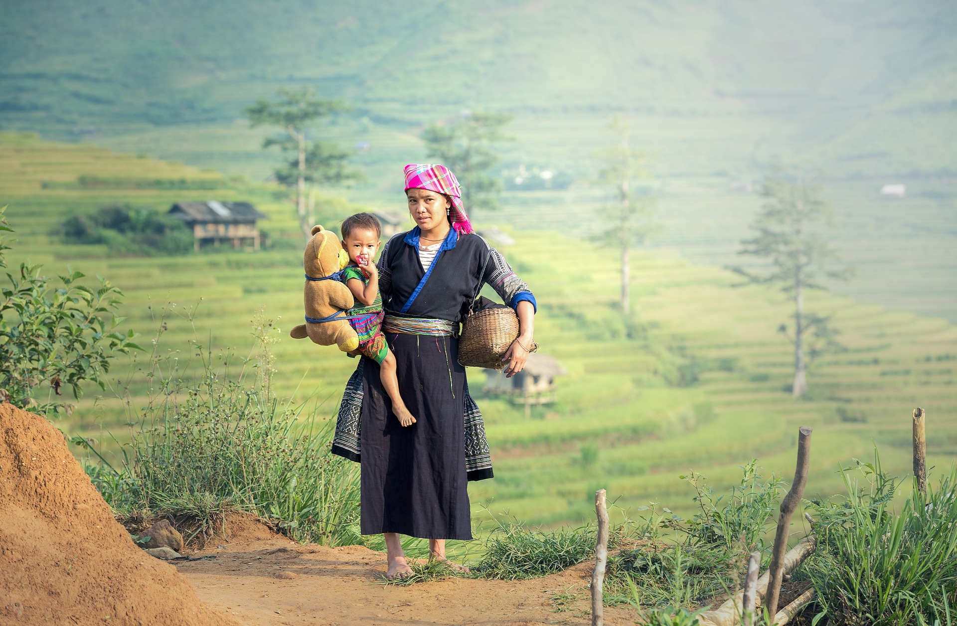An Asian woman carries her child.